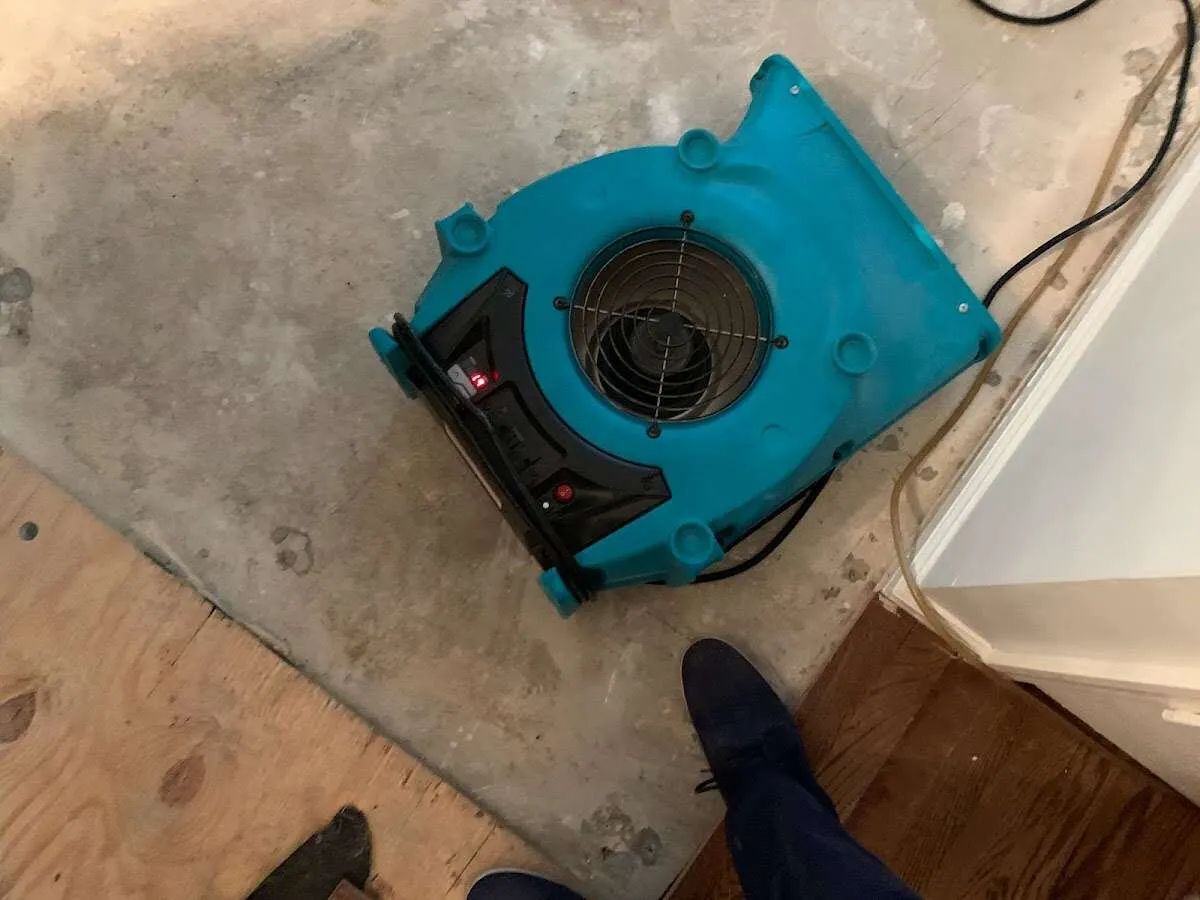 Air mover drying subfloor during Commercial Water Damage Restoration in Radnor